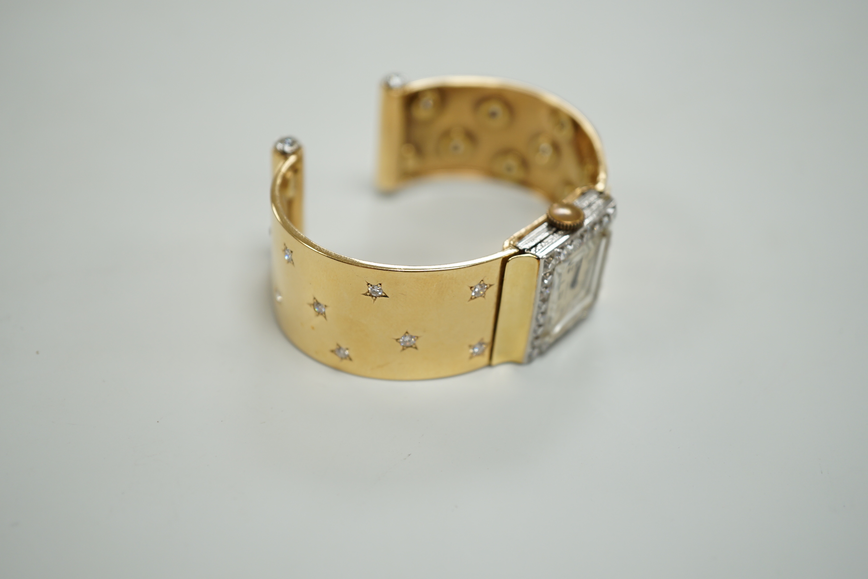 A yellow metal and diamond set Concorde manual wind open bracelet watch, with diamond set bezel and bracelet, gross weight 47.8 grams.